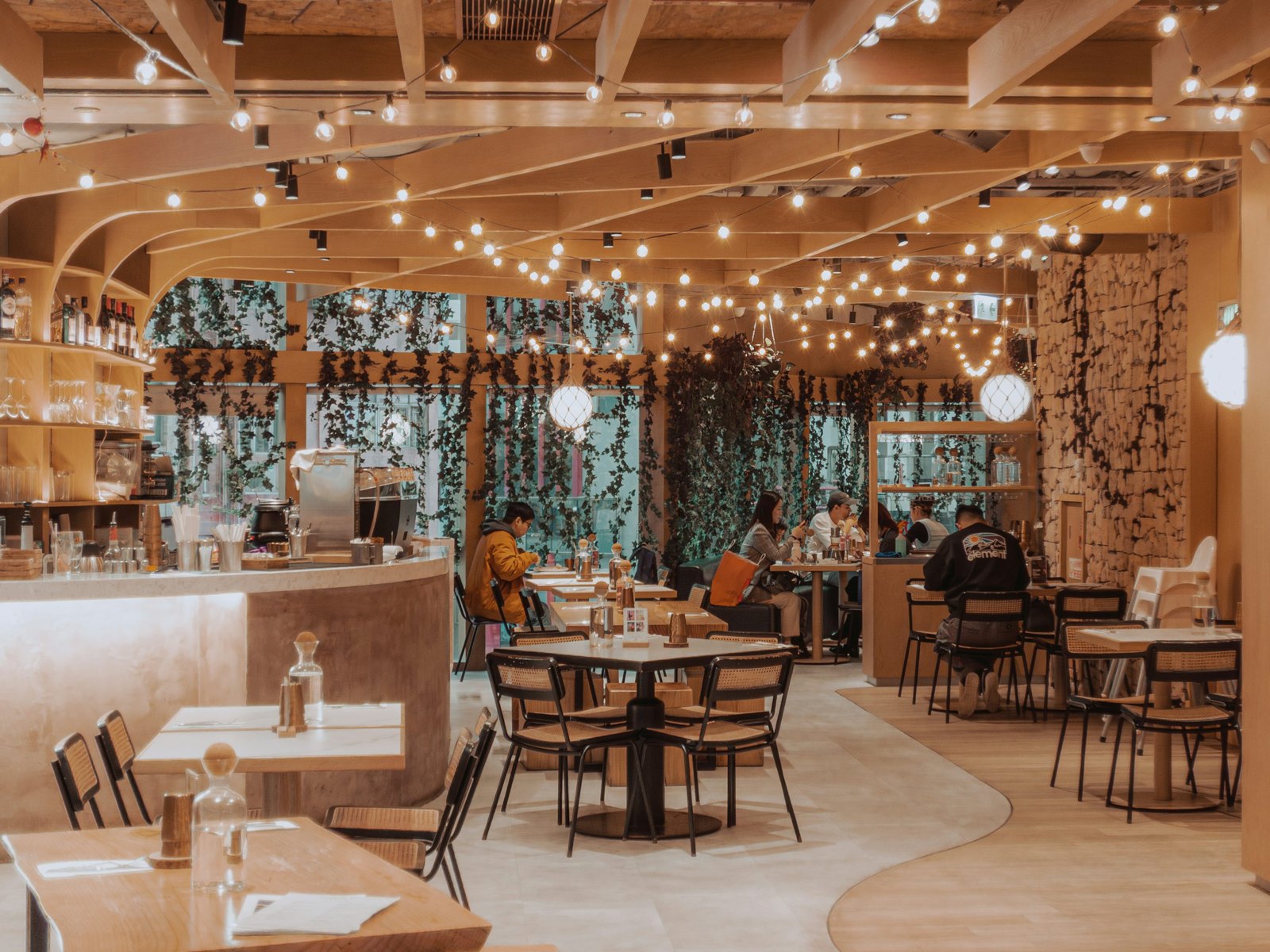 A warm café interior with tables and hanging lights